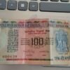 100 rupee note with sign of manmohan singh